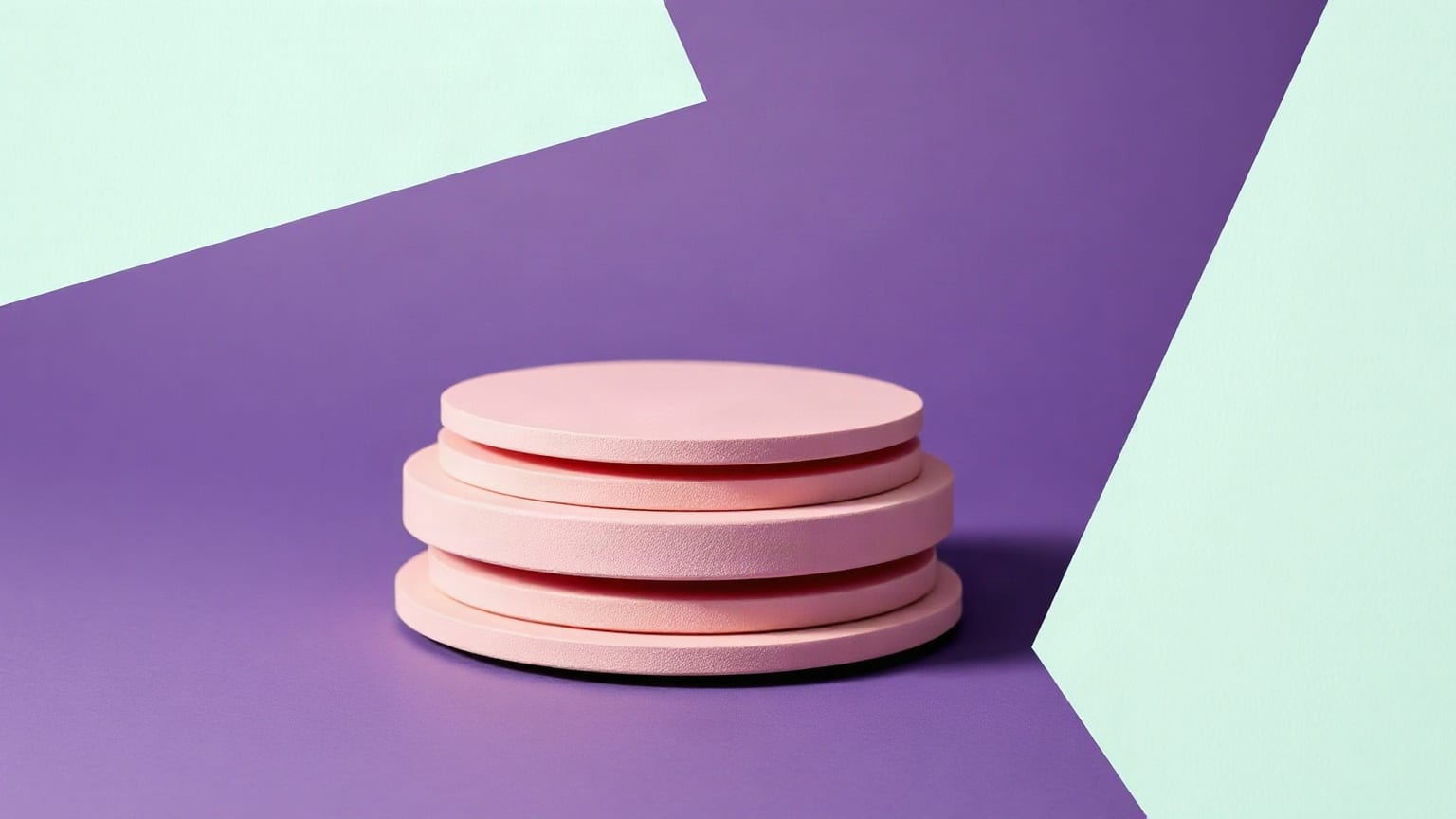 A tall stack of flat violet paper coins with the top third lifted clear of the rest